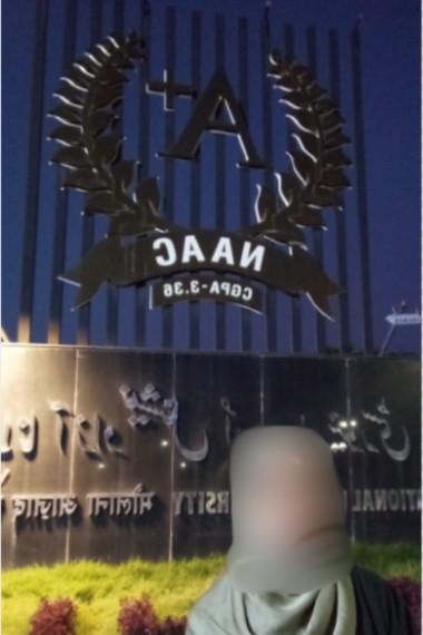 Student outside a university gate, faces blurred for privacy