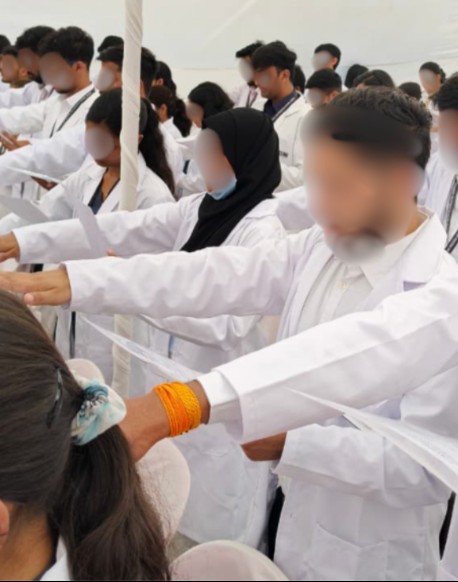 Medical students at an oath ceremony, faces blurred for privacy